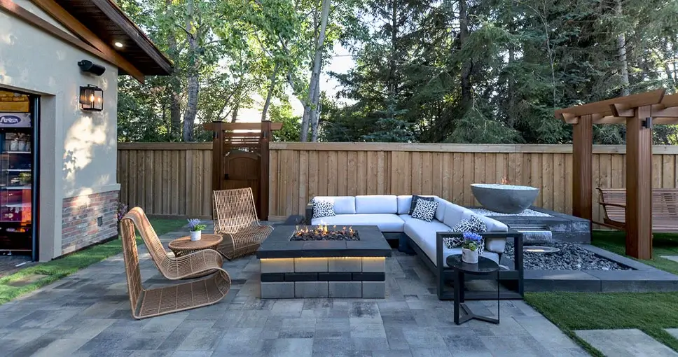 Outdoor patio with a modern fire pit and cozy seating area.