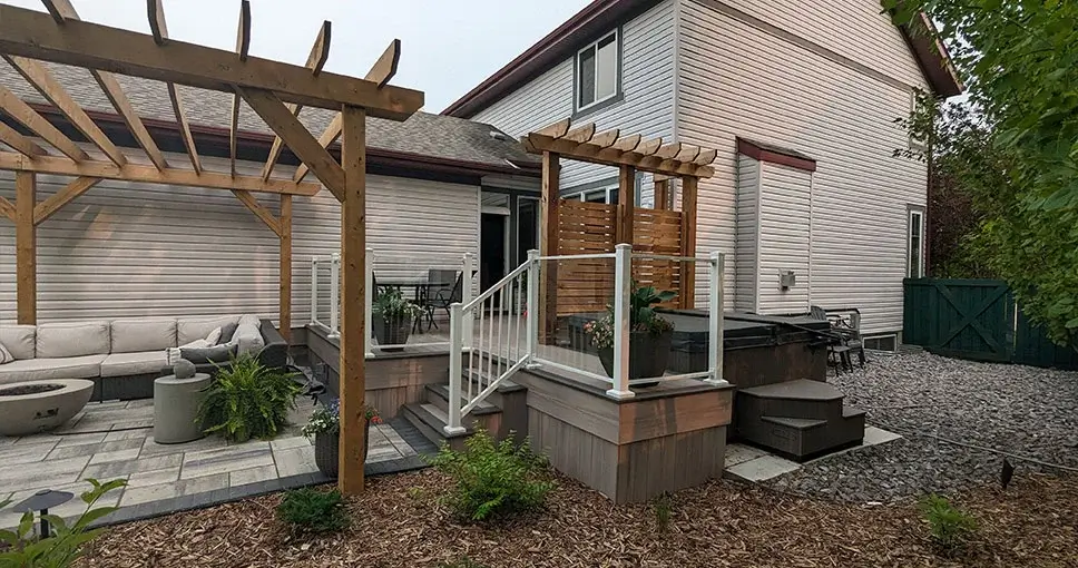 House with pergola, patio, and hot tub.