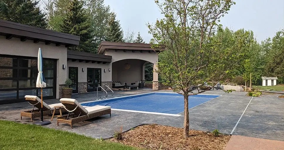 House with swimming pool and lounge chairs.