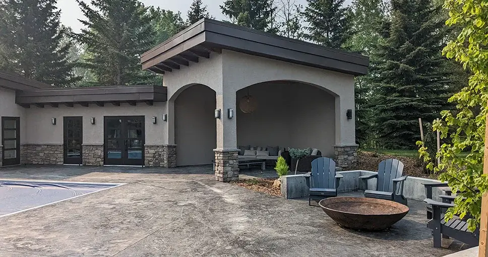 Outdoor patio with a fire pit and covered lounge.