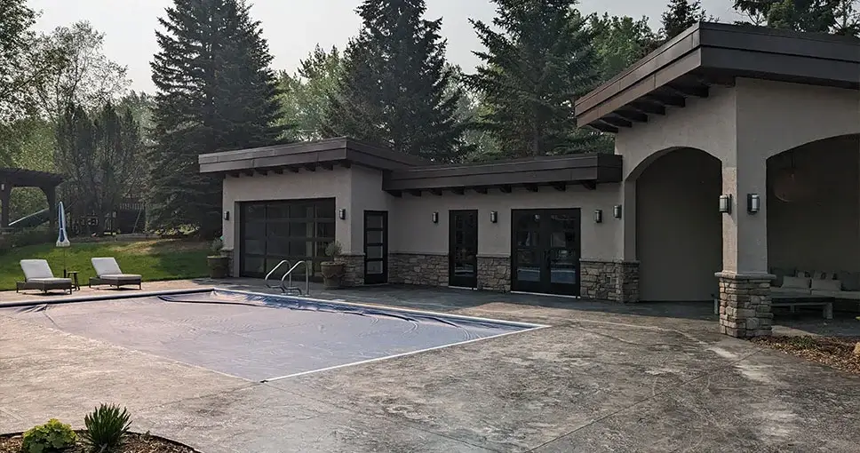 Modern outdoor pool area with a covered patio.