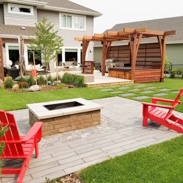 Modern backyard with firepit, pergola, and hot tub — custom landscaping and outdoor living in Edmonton.