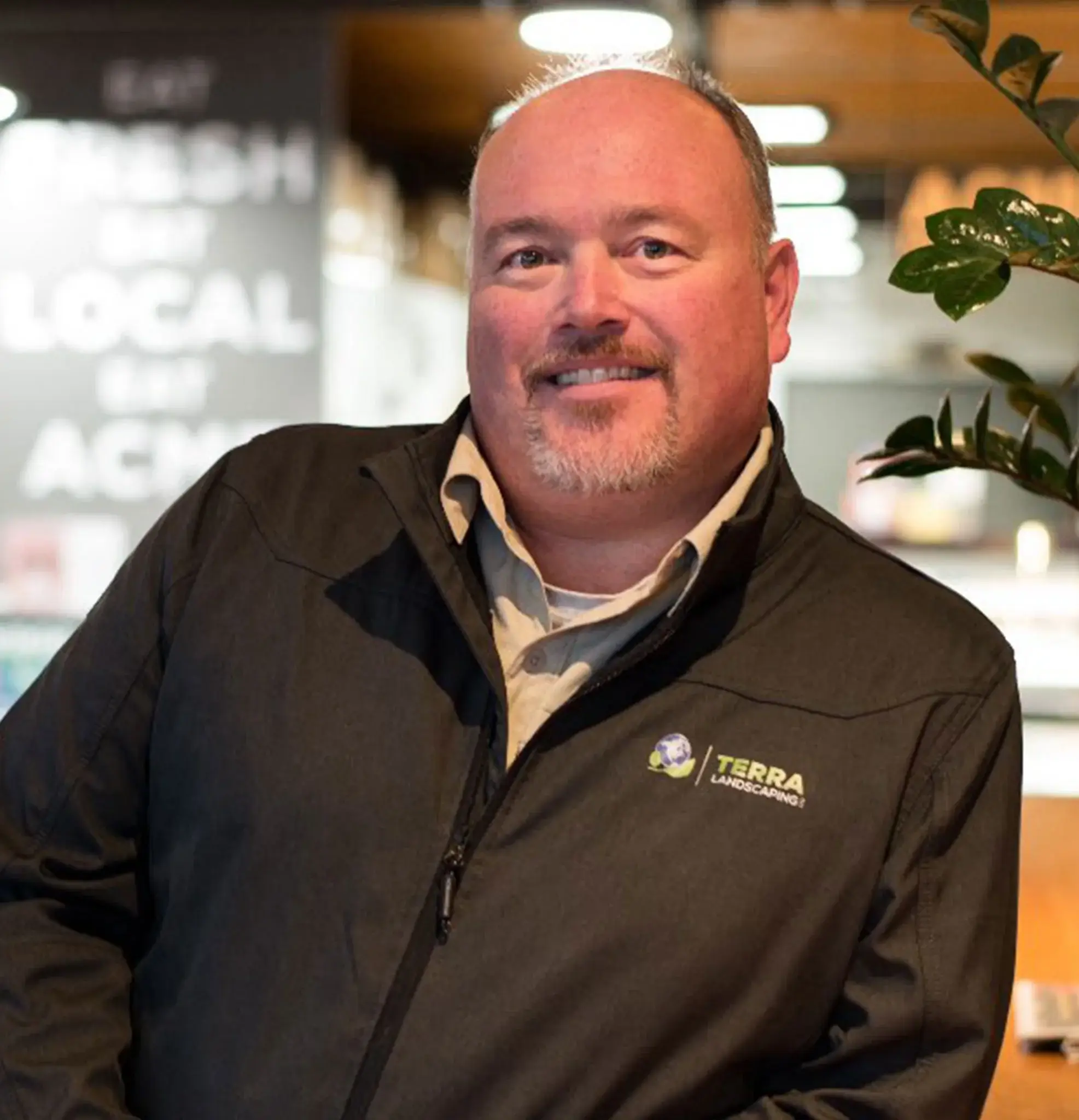 Team member wearing Terra Landscaping jacket at local event, representing a professional landscaping company in Edmonton
