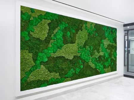 A wide, rectangular framed preserved moss wall with multi-tonal green textures and organic patterns installed in a modern office hallway.