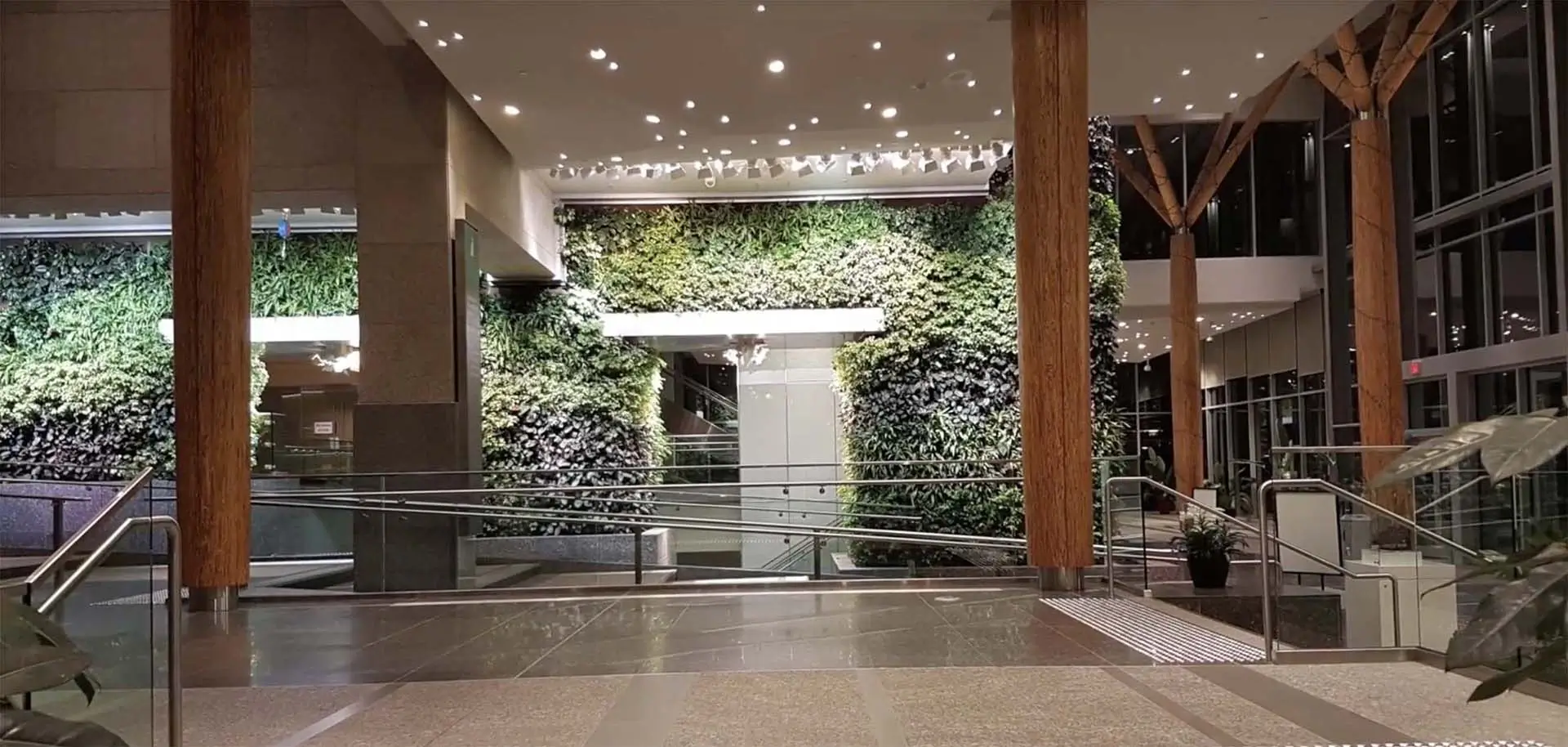 Large vertical living walls in a modern building lobby.