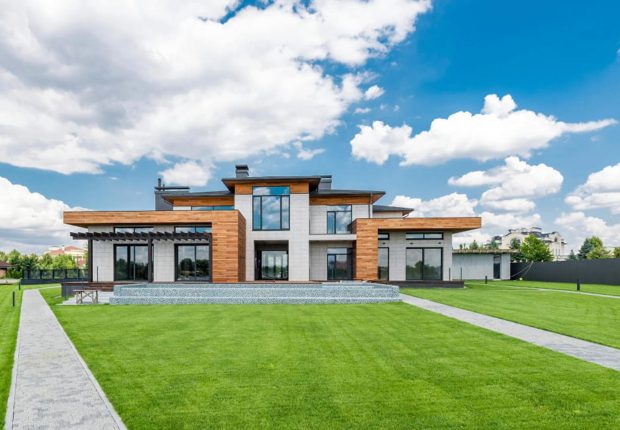Modern house with expansive green lawn.