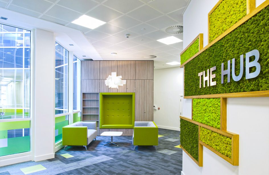 Modern Edmonton office lobby with natural moss wall decor and 'THE HUB' sign.