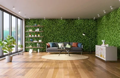 A modern living room featuring a lush green vertical garden wall, wooden flooring, and a gray sofa.