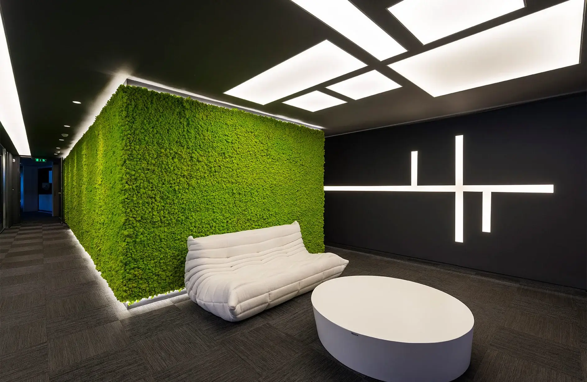 Square moss wall panels on white wall showing moss wall interior benefits like texture, color variety, and natural design.